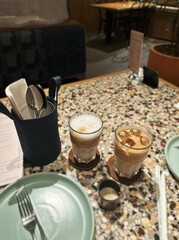 Close-Up of Iced Lattes on Cafe Table