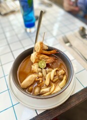 Bowl of Tom Yum Soup with Shrimp and Mushrooms