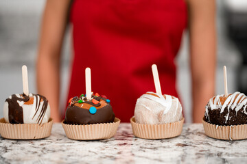 Fall Treat Held in Hands – Caramel Apple with Chocolate Topping