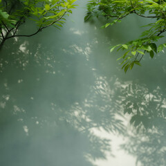 Fototapeta premium Lush green leaves of a tree are beautifully reflected in the clear, still water of a forest lake under a summer sky