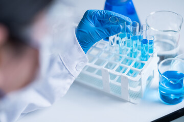 Professional healthcare medical worker doctor working for new discovery of medicine to treat disease and cancer patient research laboratory report document data analysis pharmacy future planning