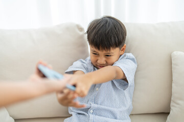 Child reaching for smartphone from parent, screen time control, tech addiction in kids, digital parenting mobile gaming habits, cartoon watching, modern family, children addicted to mobile phones