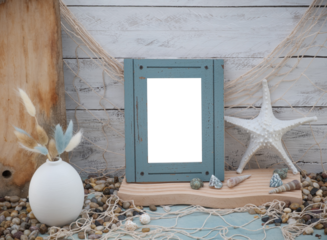 Coastal Beach Vibe closeup image with transparent picture photo frame, fishing net fishnet, shells, beach themed decorations on a weathered whitewashed wood backdrop and ocean blue green table counter