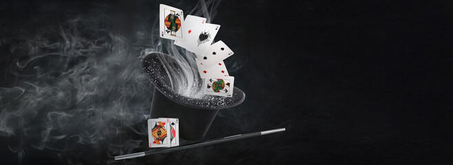 Black hat, magic wand and cards on white background © Pixel-Shot