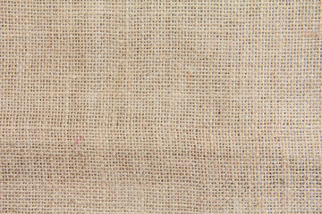 Burlap fabric made from natural fibers, background texture from brown burlap fabric made from jute, hemp or kenaf plant fibers