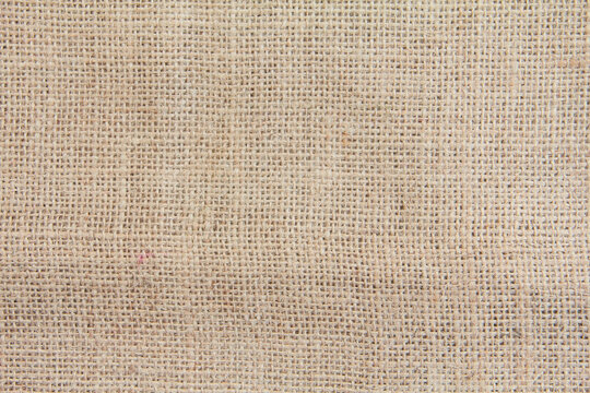 Burlap fabric made from natural fibers, background texture from brown burlap fabric made from jute, hemp or kenaf plant fibers