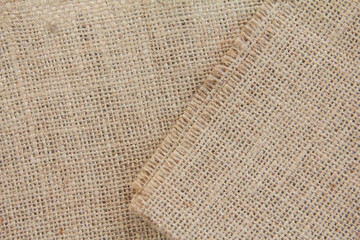 Burlap fabric made from natural fibers, background texture from brown burlap fabric made from jute, hemp or kenaf plant fibers