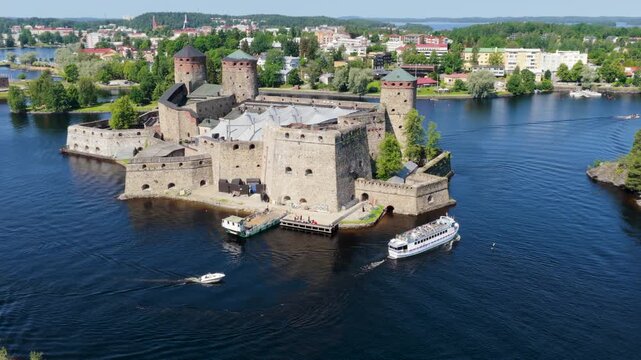 Drone flying around Fort Olofsborg while a ferry passes by, summer in Finland