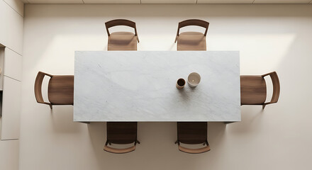Topdown view of modern white marble dining table with six wooden chairs.