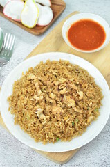 Delicious fried rice with egg, chilli, crackers and green onion, Indonesian dish.