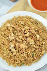 Delicious fried rice with egg, chilli, crackers and green onion, Indonesian dish.