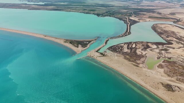 Aerial view of vibrant coastal lagoon with sandy beach and turquoise waters