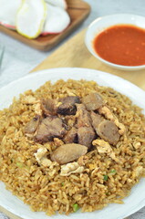Delicious beef fried rice with egg, chilli, crackers and green onion, Indonesian dish.