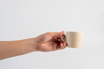 Coffee in a white cup and hand, coffee in a glass, cup on white background