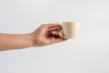 Coffee in a white cup and hand, coffee in a glass, cup on white background