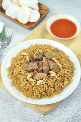 Delicious beef fried rice with egg, chilli, crackers and green onion, Indonesian dish.