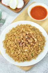 Delicious chicken fried rice with egg, chilli, crackers and green onion, Indonesian dish.