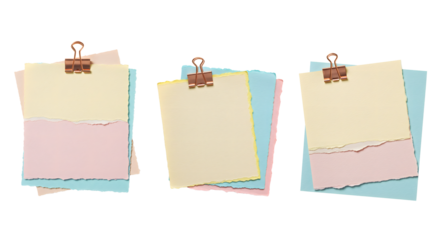 Torn pastel paper sheets with binder clips for creative design projects..
