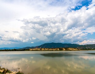 Fototapeta premium Calm lake reflecting a dramatic sky (1)