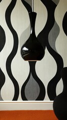 Sleek black pendant lamp hangs against a wavy, monochrome wall