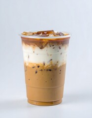 A layered iced coffee drink in a clear plastic cup, showcasing the different ingredients.