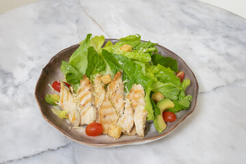 Fresh chicken and vegetable salad served on a plate