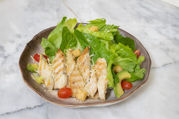 Fresh chicken and vegetable salad served on a plate