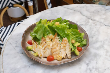 Fresh chicken and vegetable salad served on a plate