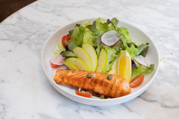 Grilled salmon steak with vegetables on a plate