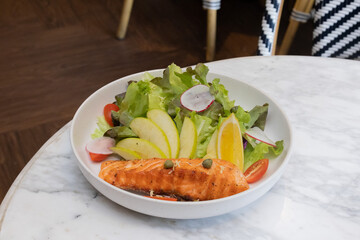 Grilled salmon steak with vegetables on a plate