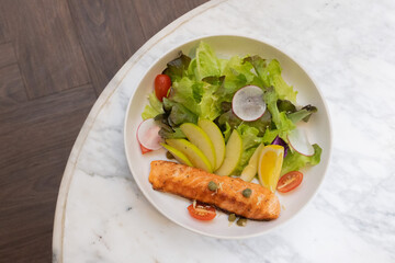 Grilled salmon steak with vegetables on a plate