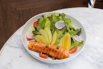 Grilled salmon steak with vegetables on a plate