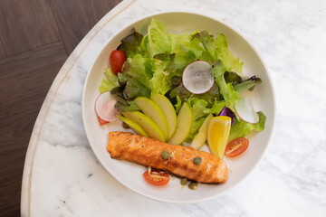 Grilled salmon steak with vegetables on a plate