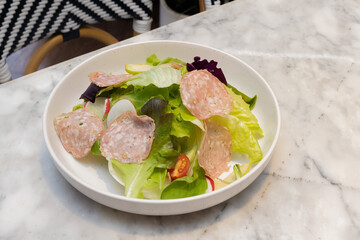 Fresh salad served in a glass bowl