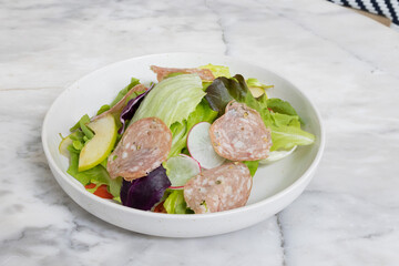 Fresh salad served in a glass bowl