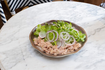 Fresh raw fish fillet served on a plate with vegetables