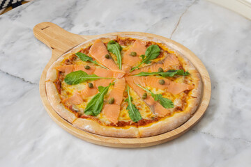 Baked pizza with smoke salmon and melted cheese casserole