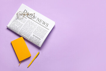 Daily newspaper with glasses and notebook on purple background