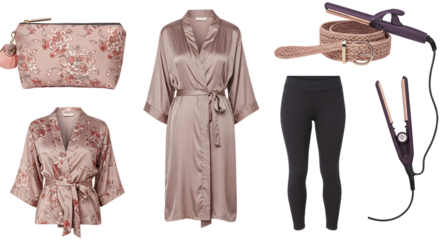 LIFESTYLE - Flat lay of feminine beauty and fashion essentials including floral cosmetic bag, satin robes, black leggings, wicker basket, and hair styling tools on white background