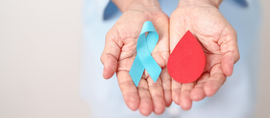Elderly woman with Blue ribbon and red Blood drop for World Diabetes Day, Blue November Health, Prostate Cancer awareness, Blood sugar check, Insulin, Glucose screening, donation and Health checkup
