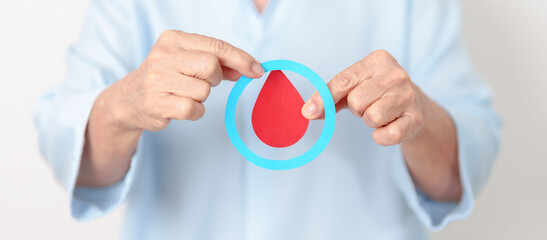 Elderly woman with Blue Circle and red Blood drop for World Diabetes Day, Blue November Health month, Diabetes awareness, Blood sugar check, Insulin, Glucose screening, donation and Health checkup