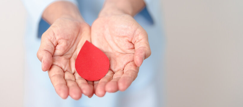 Elderly woman in blue shirt with red Blood drop for World Diabetes Day, Blue November Health month, Diabetes awareness, Blood sugar check, Insulin, Glucose screening, blood donoo and Health checkup