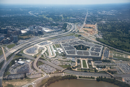 Aerial view of the Pentagon complex with surrounding roads, parking and greenery. g.