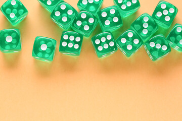 Green game dices on orange background
