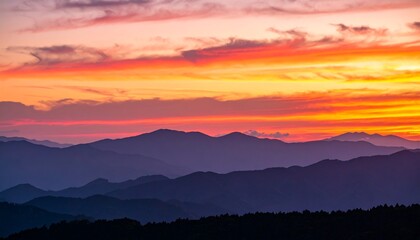 Mountain silhouettes at fiery sunset
