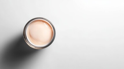 32.Flat-lay composition of thick and velvety yogurt in a transparent bowl, perfectly centered on a pure white backdrop