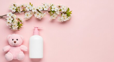 Gentle baby care essentials with delicate blossom branch and teddy bear