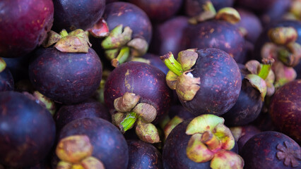 background of market in asia with fresh tropical mangosteen or garcinia mangostana in southeast asia known as the queen of fruits