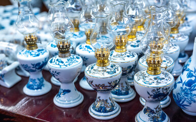 Traditional Vietnamese blue porcelain utensils with vases, dishes, altar items on dispenser at street market in Hoa Lu old city, Ninh Binh, Vietnam. Handmade souvenirs of crockery for daily use