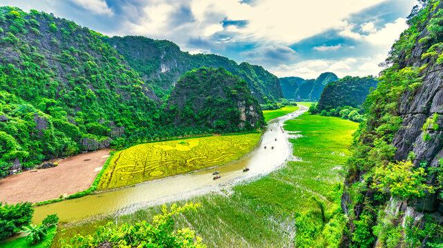 Tam Coc landscape with limestone mountains, river and rice field on Ngo Dong stream, Ninh Binh, Vietnam